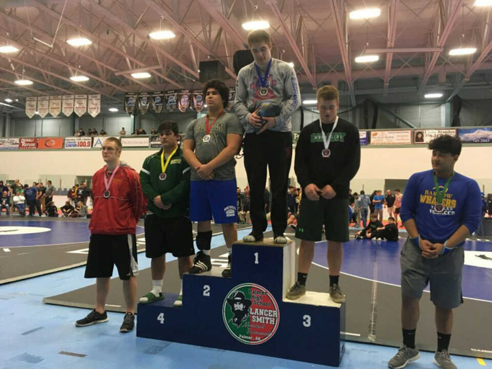 JDHS senior wrestler Cody Weldon stands atop the podium at the Lancer Smith Memorial Tournament last weekend. Weldon beat Palmer High School's Austin Farris for the tournament title at 220 pounds.