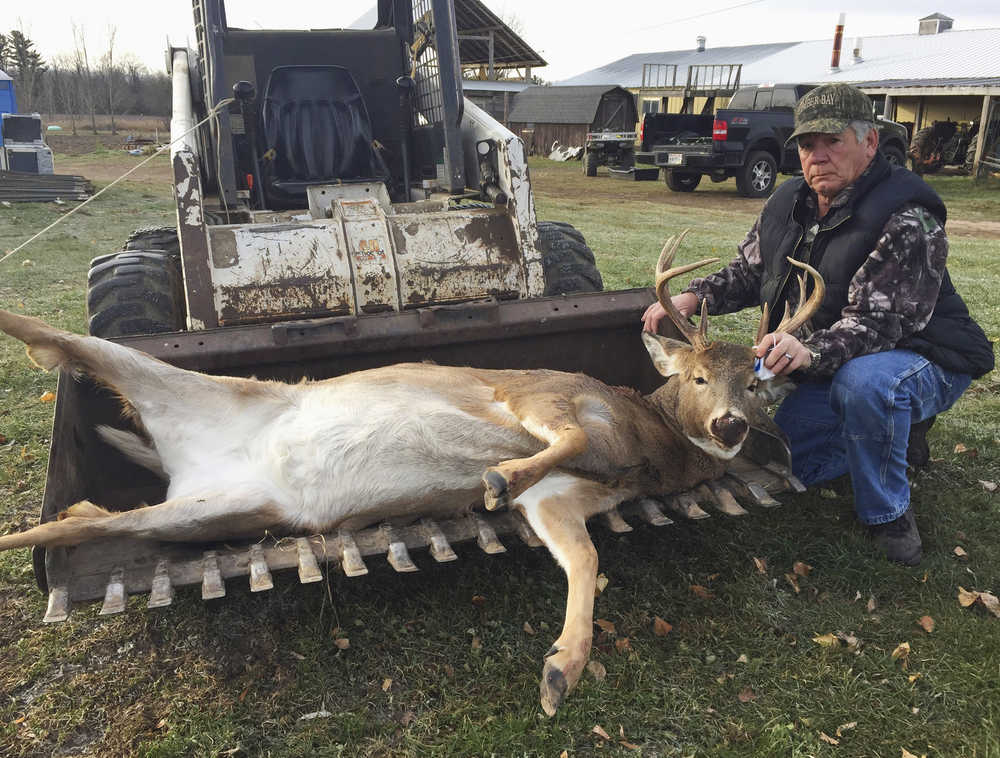 In this Tuesday, Nov. 22, 2016 photo, provided by Mel Buckmaster, Wayne Douville poses with an eight-point doe he shot in Abrams in northeastern Wisconsin.