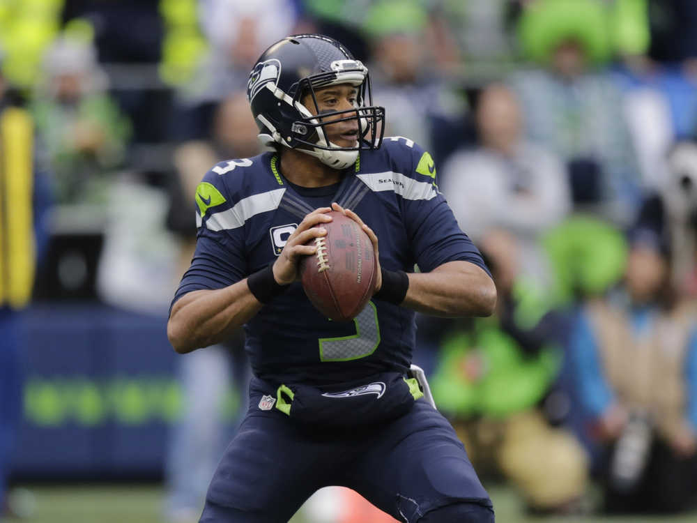 Seattle Seahawks quarterback Russell Wilson looks to pass during the first half of an NFL game against the Philadelphia Eagles on Nov. 20, in Seattle. (Stephen Brashear | The Associated Press)