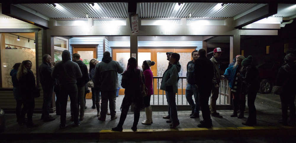 Invited guests wait in line outside of Rainforest Farms Second Street store to buy the first legal marijuana in Juneau on Wednesday, Nov. 23, 2016. The store is open to the public today.