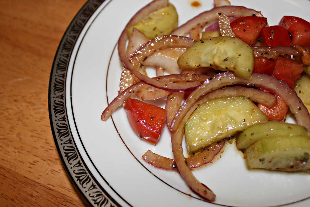 Tomato cucumber salad is an easy crowd-pleaser and can be served with or without onions.