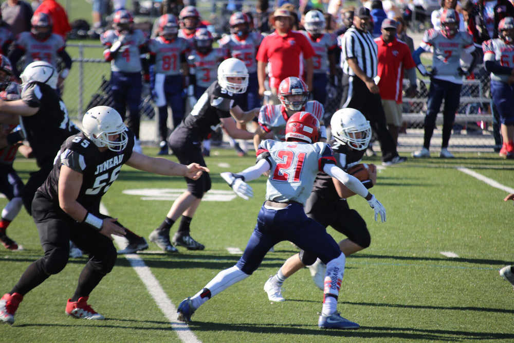 Juneau Raiders football player Cody Morehouse avoids defenders during their National Youth Football Championship game against the Camarillo Cougars.
