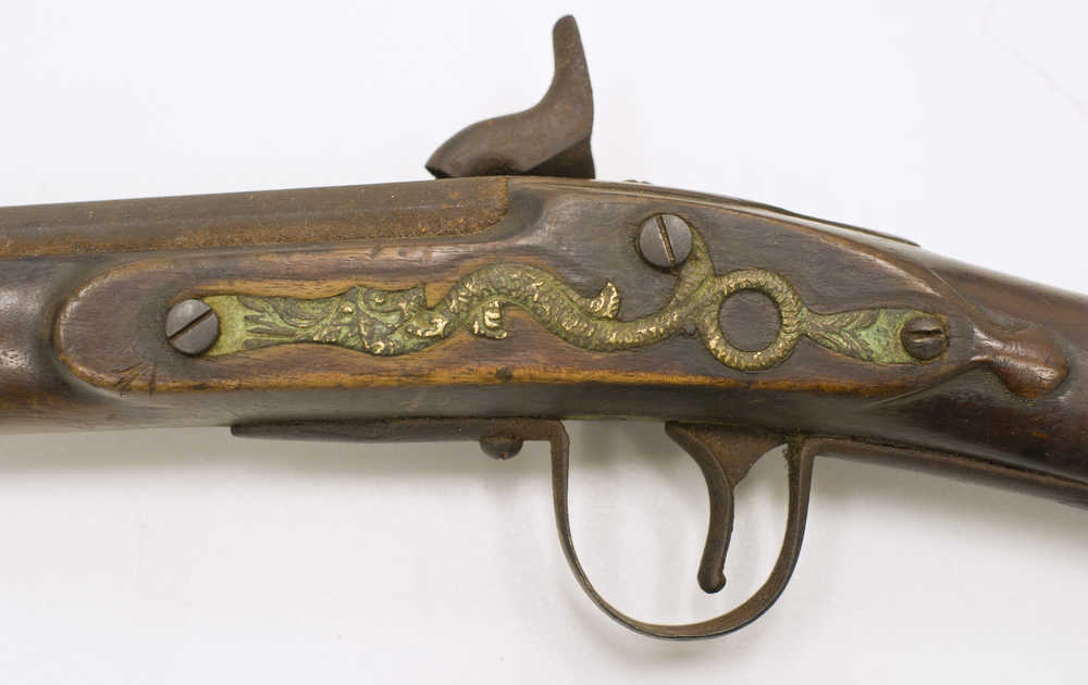 The serpent side plate seen here on Friday, Dec. 2, 2016 appears on a smoothbore musket sold by the Hudson's Bay Company in the late 19th century and now held in the collections of the Alaska State Museum. The serpent motif first appeared on Dutch muskets sold to American Indians in New England during the early 17th century, but it stayed emblazoned on trade muskets sold to Natives and Indians in North America for almost 300 years.