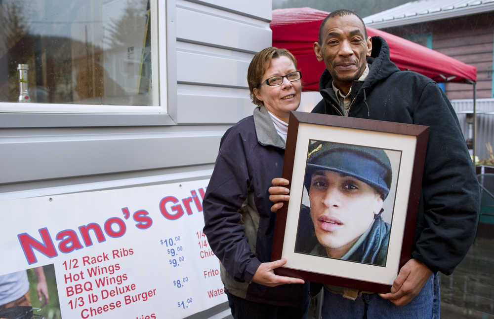 Kerry and Richard Wycoff hold a picture of their son, Michael, on Friday, Dec. 2, 2016, in front of a new business they are starting in his honor located at Louie's Douglas Inn.