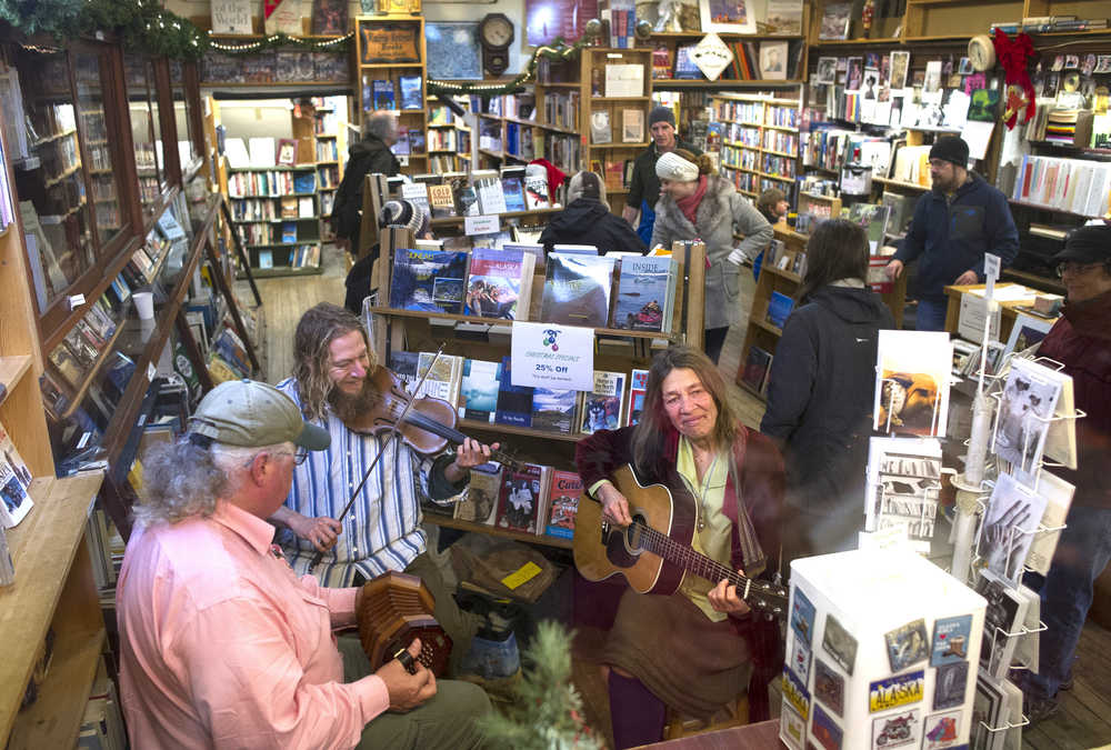 Liz Saya, right, her son, Lief, center, and her husband, Greg McLaughlin provide live folk music at Rainy Retreat Books during Gallery Walk on Friday, Dec. 2, 2016.