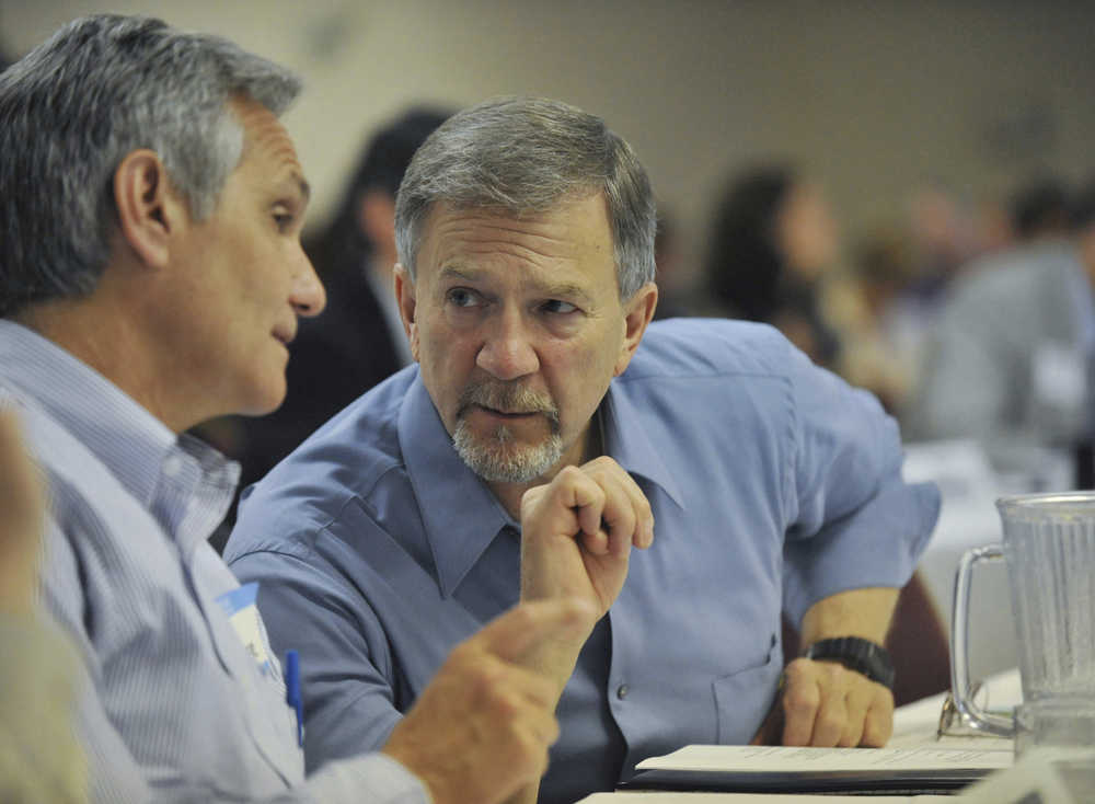 In this June 17, 2008 file photo, Alaska state Reps. Mike Kelly, right, and Kevin Meyer, left,  confer during the legislature's special session on the proposed gas pipeline in Anchorage. A man killed in a plane crash Wednesday has been identified by his wife as former Republican state Rep. Mike Kelly of Fairbanks.