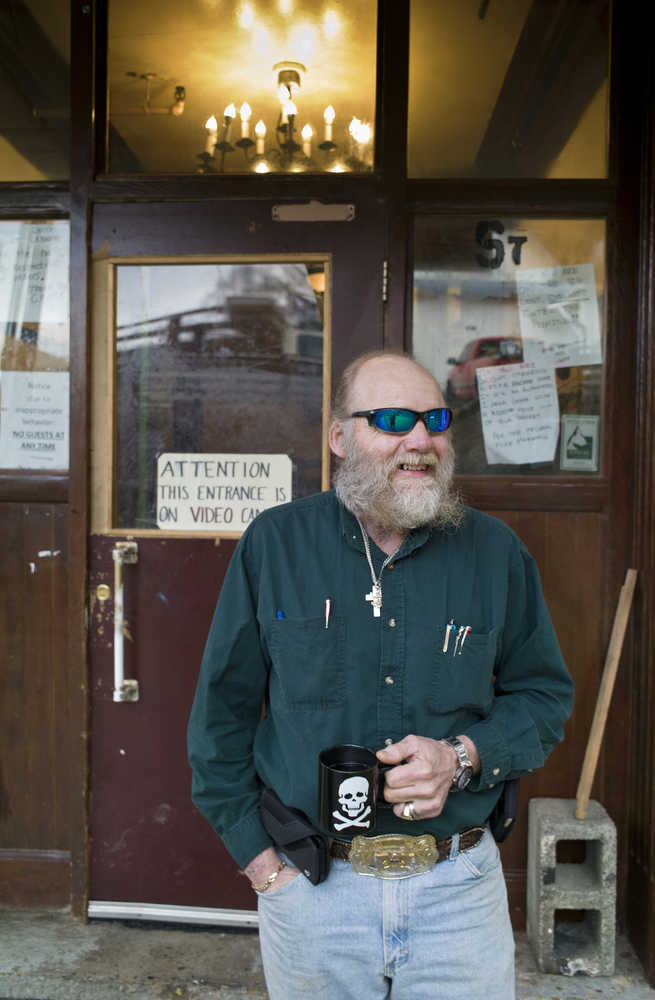 Charles Cotten Jr., the new manager of the Bergmann Hotel, surveys the front of the hotel on Wednesday, Nov. 30. Cotten says his plan of attack is simple. Step one: "Clean up the people." Step two: "Clean up the building."