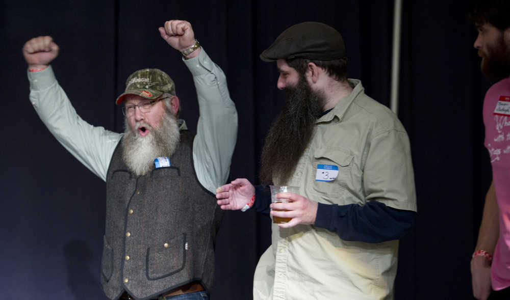Jeff Boehm celebrates his win in the full beard competition during the second annual LumberJACC Beard & Moustache contest as fellow contestants Jacob Gemmbell, center, and Nick Rutecki look on at the Juneau Arts & Culture Center on Friday.