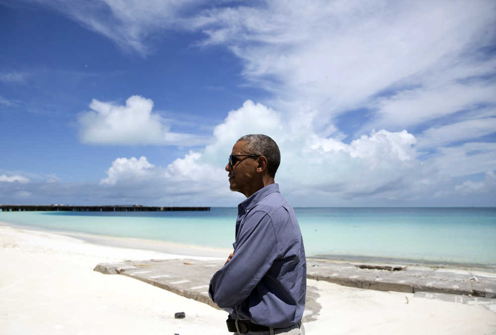 FILE - In this Sept. 1, 2016, file photo, President Barack Obama looks out over Turtle Beach as he tours Midway Atoll in the Papahanaumokuakea Marine National Monument, Northwestern Hawaiian Islands. Obama will leave behind a host of disputed actions and unfinished business on the environment, from blocked energy leases and mining projects to recent pollution restrictions and decisions on hundreds of potentially-imperiled species. Republicans emboldened by Donald Trump's victory are gearing up to reverse many of the administration's signature environmental moves. (AP Photo/Carolyn Kaster, File)
