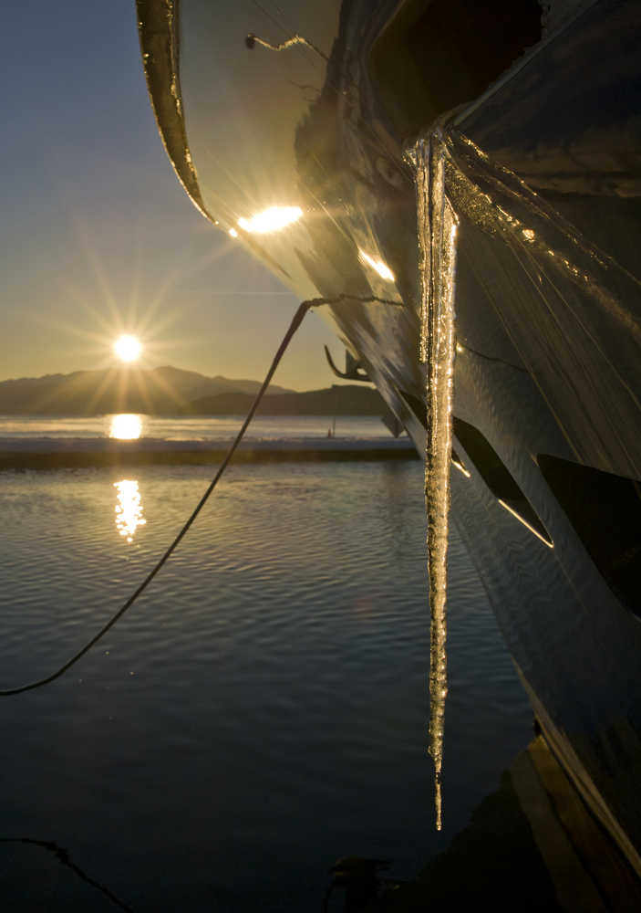 Icicles grow longer as the sun hugs the horizon at the Don D. Statter Memorial Boat Harbor in Auke Bay on Thursday, Dec. 15, 2016.