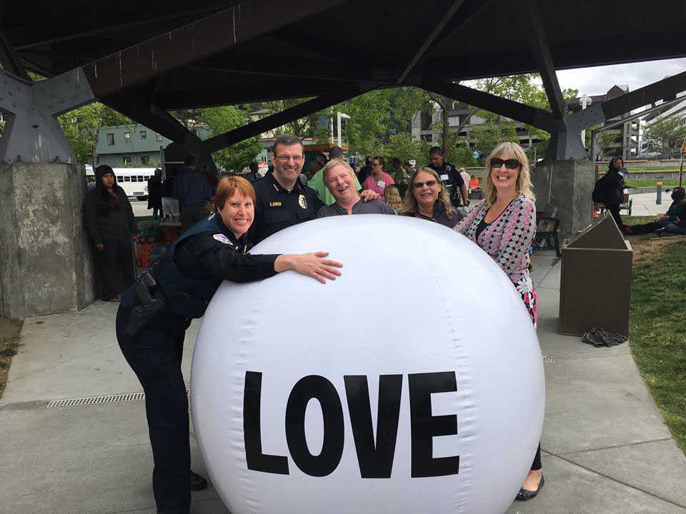 Lt. Kris Sell hugs the Juneau Radio Center Love Ball.