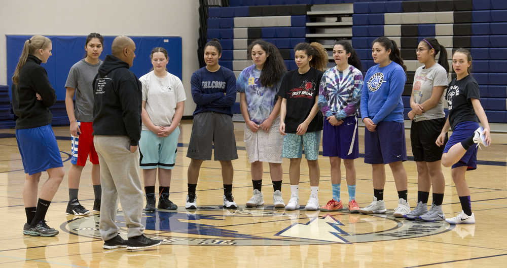 Thunder Mountain High School girls basketball Head Coach Chandler Christensen, left, and Assistant Coach Vince Yadao speak with their team before practice at TMHS on Tuesday, Dec. 13, 2016.