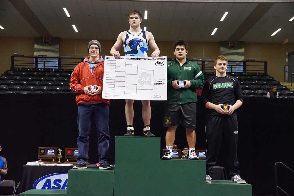JDHS senior Cody Weldon stands atop the podium at the Alaska Scholastic Activities Association state wrestling championships on Saturday. Weldon won the state title at 220 lbs, beating Service High School's Kaden Caldarera, center right. West Valley's Gideon Cole, left, took third while Isaiah Christy of Colony, right, finished fourth.