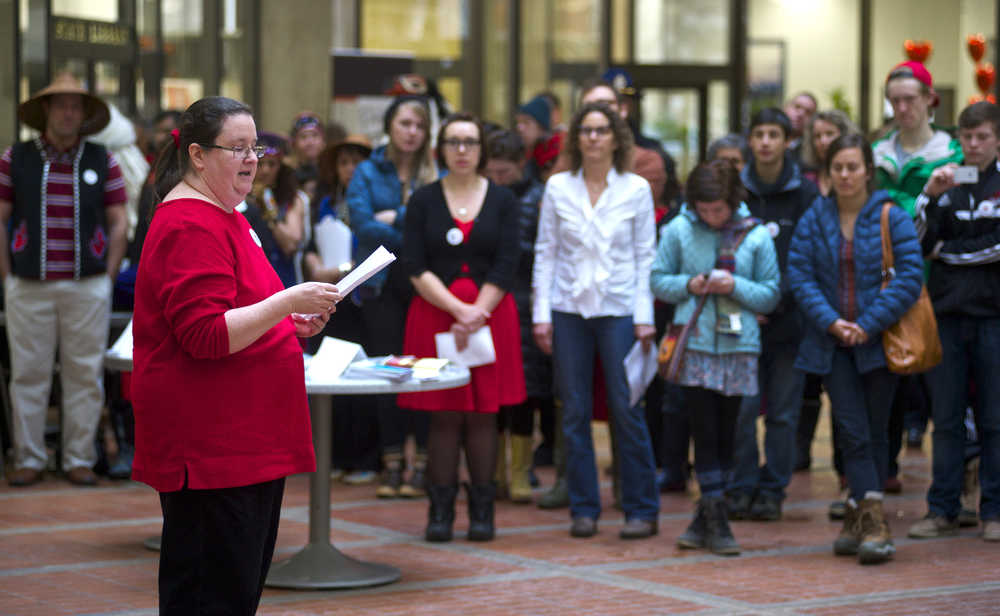 Lauree Morton, Executive Director of the Council on Domestic Violence at the Alaska Department of Public Safety, welcomes people to the One Billion Rising for Justice event at the State Office Building's atrium on Friday, Feb. 14, 2014.
