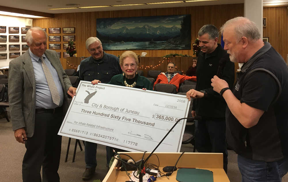 Members of the Whale Project present a $365,000 donation to the City and Borough of Juneau on Monday, Dec. 19, 2016 for waterworks around the namesake sculpture that has been erected near the Juneau-Douglas bridge.