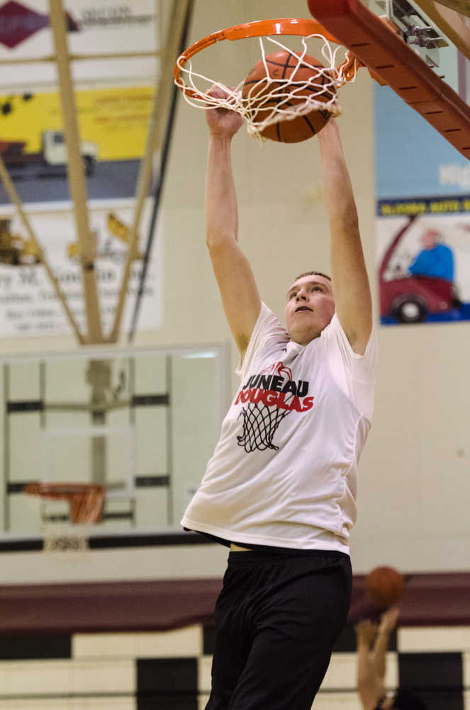 Juneau-Douglas's Eric Kelly dunks the ball during their Dec. 15 practice.