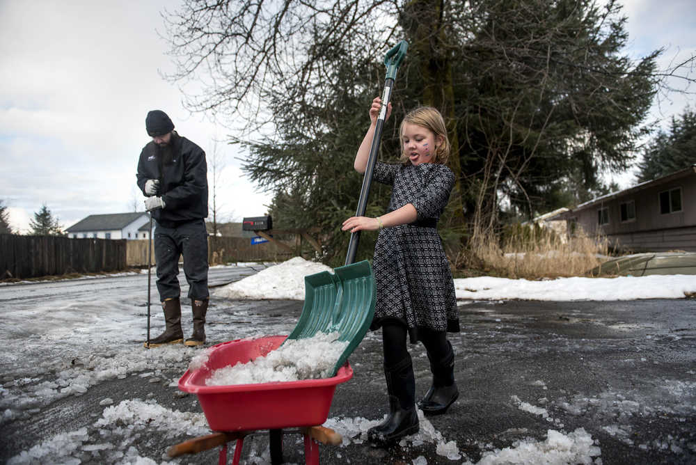 Hazel Metzgar, 6, helps her father Cameron clear the ice from her grandfather's driveway on Radcliffe Road in the Mendenhall valley on Dec. 22, 2016. Cameron grew up in Juneau and now lives in Port Alsworth on Lake Clark, Alaska, and is in town for the holidays visiting his father with his wife and children.