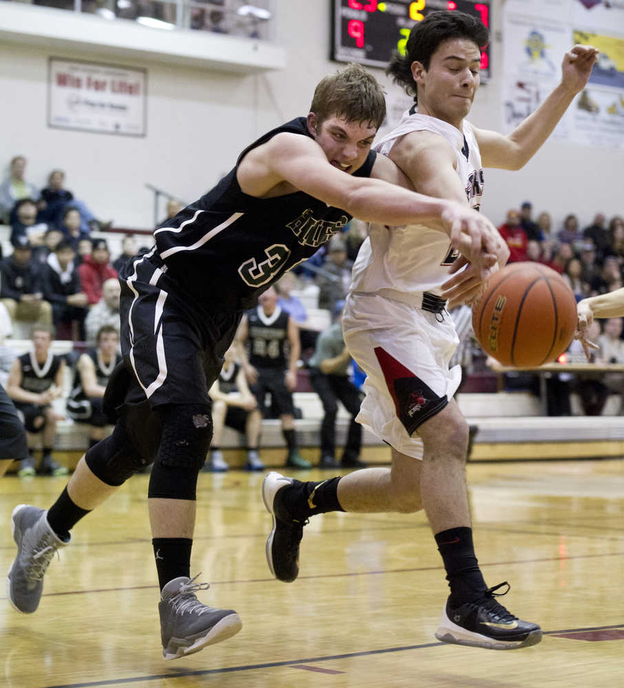 Juneau-Douglas' Marshall Shapland-Murray, right, and Haines' Dylan Swinton chase a loose ball during the Capital City Classic at JDHS on Tuesday, Dec. 27, 2016.