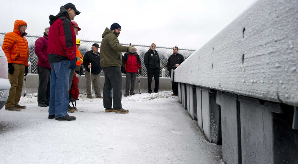 Matthew Sill, center, an engineer with PND Engineers, explains their design of the new floats that are being used in the remodel of the Douglas Harbor during a tour on Wednesday, Jan. 4, 2017.