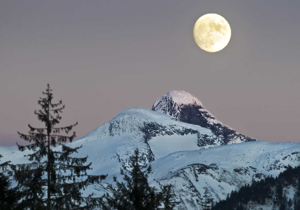 A nearly full moon rises over a mainland peak on Tuesday, Jan. 10, 2017. The full moon is on Thursday.
