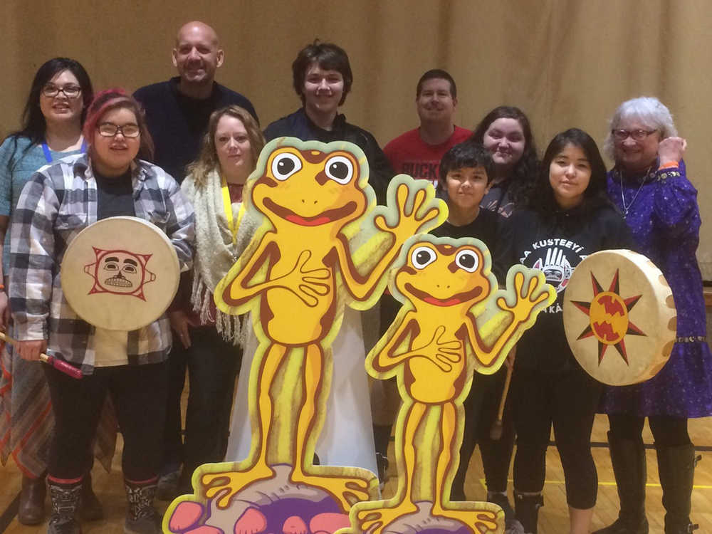 Hoonah students and teachers stand with Sparks the orange frog as part of the Happiness Advantage training done by GoodThink.
