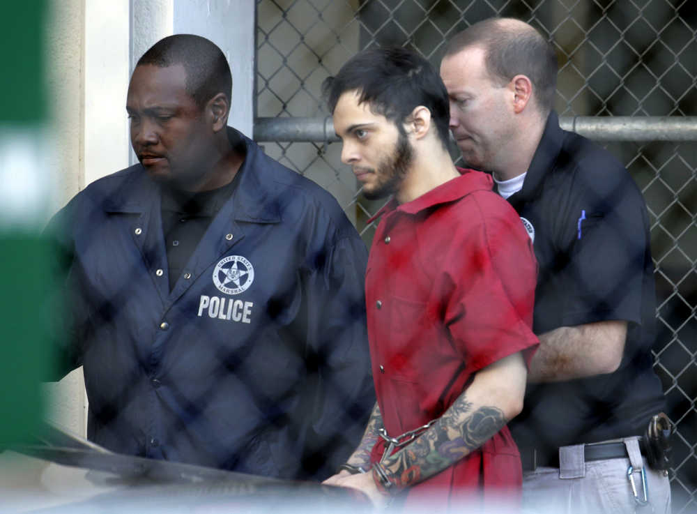 Esteban Santiago, center, leaves the Broward County jail for a hearing in federal court Tuesday in Fort Lauderdale, Florida.