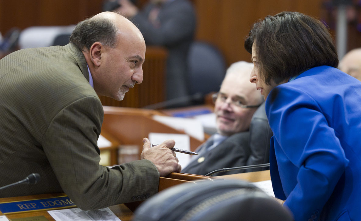 Rep. Les Gara, D-Anchorage, left, talks with Rep. Liz Vazquez, R-Anchorage, as Rep. Bob Herron, D-Bethel, looks on during the first day of the 29th Legislature at the Capitol in Juneau on Tuesday, Jan. 19, 2016.