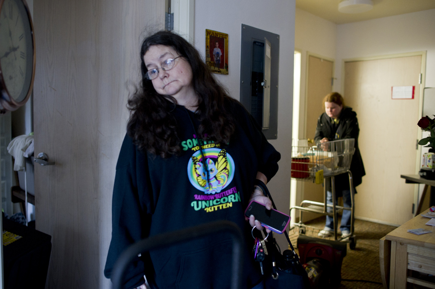 Hazel LeCount, left, and her daughter, Shannon, look for what to salvage on Thursday after Sunday's fire at the Channel View Apartments. The fire started in apartment 5E on the fifth floor of the 22-apartment building managed by St. Vincent de Paul. All the water end up in LeCount's apartment, 1E, on the first floor. The odor is so foul that the women can only stay in the room for a few minutes at a time.
