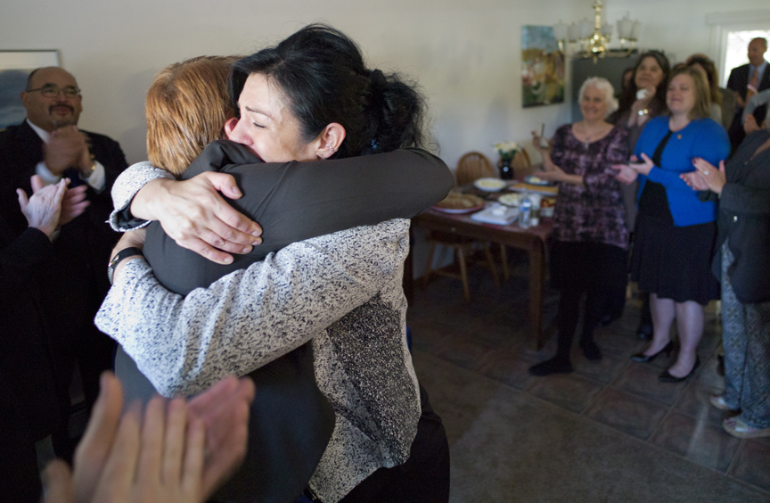 Kara Nelson, director of the Haven House, right, hugs Juneau Police Department Lt. Kris Sell during remarks before the signing of Senate Bill 91, an omnibus criminal law and procedure bill, into law by Gov. Bill Walker at Haven House on Monday.