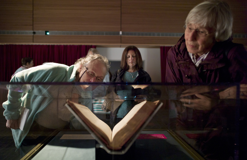 Vaughn Westcott, left, Fran Ritts, visiting from Long Island, New York, center, and Barbara Pavitt look at a First Folio edition of William Shakespeare's plays that went on display at the State Library, Archives and Museum building on Tuesday. One of only 234 known surviving copies, the nearly 400-year-old book containing 36 plays will be on display until Aug. 24.
