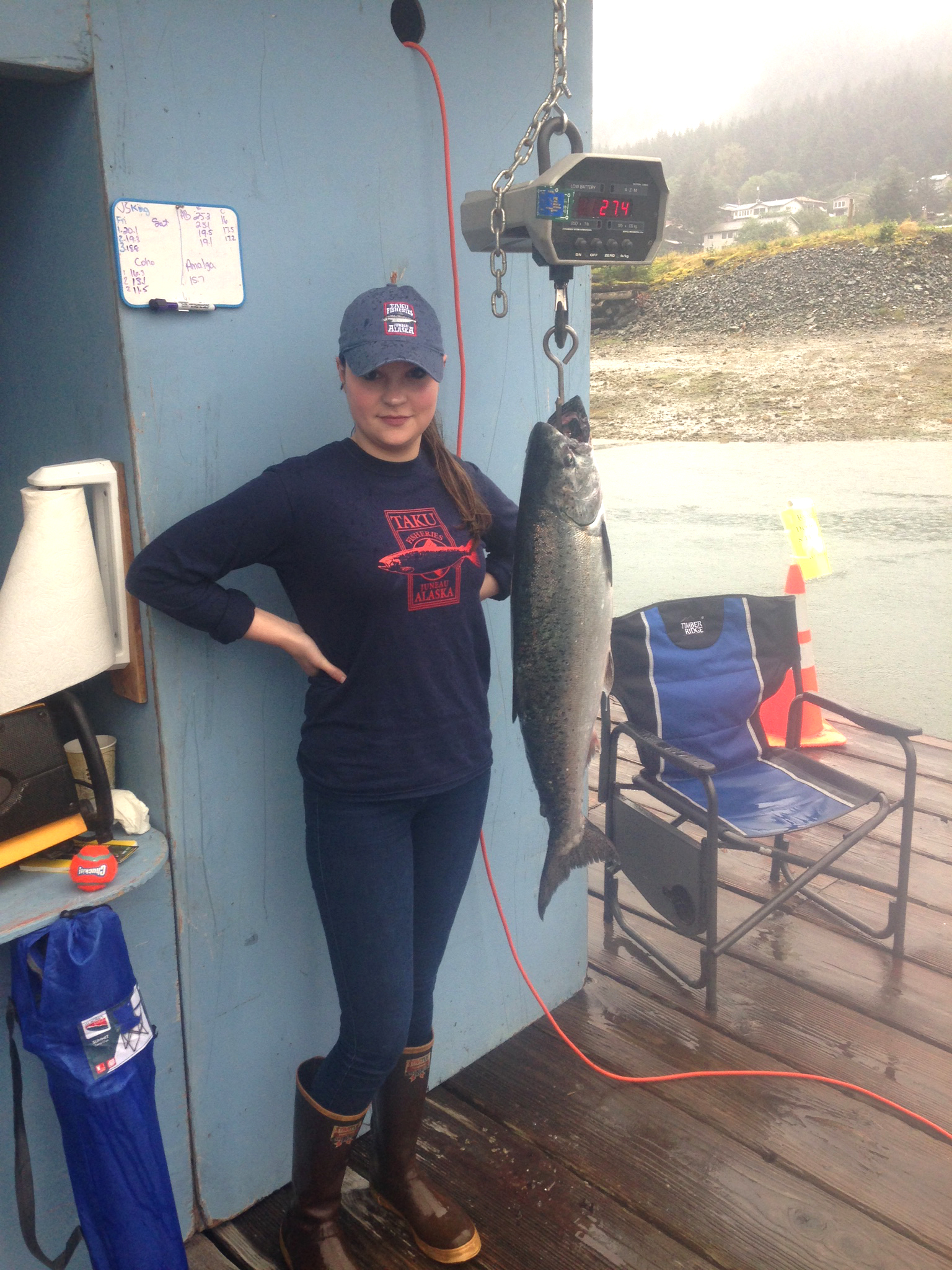 Katherine Dimond, 23, stands beside her winning 27.4 pound catch on Friday at the Douglas weighing station. Dimond's catch was the largest during the three-day 2016 Golden North Salmon Derby.