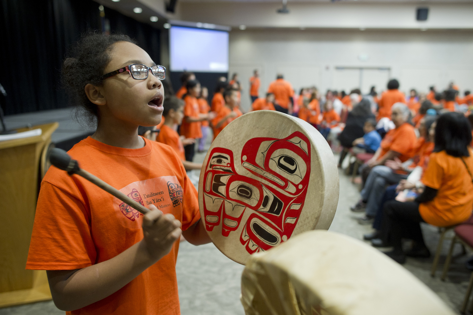 Harborview Elementary School fifth-grader Remi Starks drums during Orange Shirt Day in the Elizabeth Peratrovich Hall on Friday.