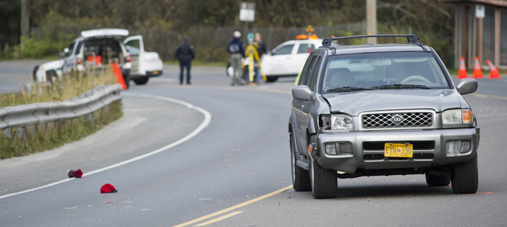 Juneau Police Department officers investigate the site of vehicle/pedestrian accident in the Lemon Creek area on Friday.