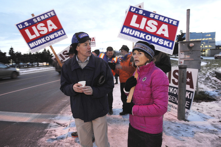 Sen. Lisa Murkowski, R-Alaska, right, and Democratic state house candidate Matt Claman share election day views on a street corner, Tuesday in Anchorage.