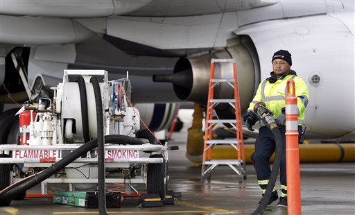 Airport worker Resky Killion stows gear after pumping fuel into an Alaska Airlines jet, Wednesday, Dec. 16, 2015, at Seattle-Tacoma International Airport, in SeaTac, Wash. Boeing Co., Alaska Airlines and the Port of Seattle announced Wednesday that they are partnering on a $250,000 study to explore how to bring more aviation biofuel to airplanes at Seattle-Tacoma International Airport. Executives for the companies and port signed an agreement, saying the study will help stimulate production of alternatives to conventional jet fuel. They say the longer term plan is to incorporate more biofuel into the airport’s fuel farm, which is used by all 26 airlines.