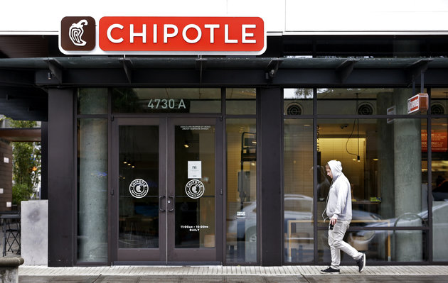 A pedestrian walks past a closed Chipotle restaurant Monday, Nov. 2 in Seattle. An E. coli outbreak linked to Chipotle restaurants closed 43 of its Pacific Northwest locations after the chain’s third foodborne illness this year sickened about two dozen people.