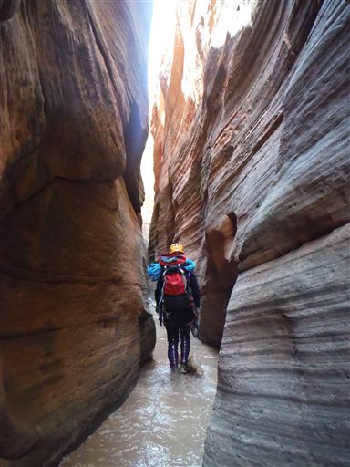 This 2013 photo provided by the National Park Service shows canyoneering in Keyhole Canyon, in Zion National Park, near Springdale, Utah. Zion National Park officials are retracing what led up to the deaths of seven people in a flooded canyon on Sept. 14, 2015, before a panel assesses what can be done to keep a growing number of visitors safe when spectacular natural settings turn perilous.