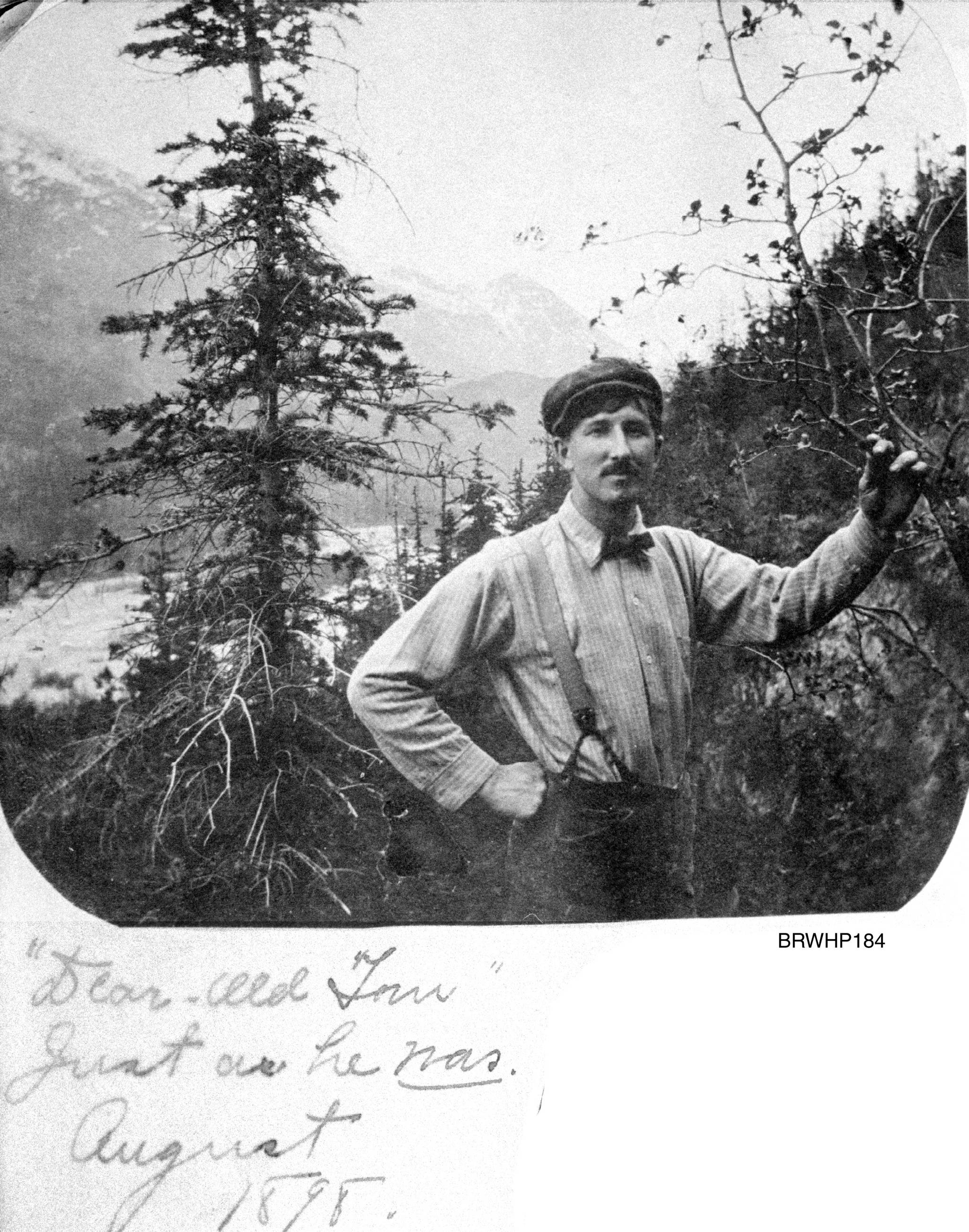 “Dear old Tom just as he was” looking southeast, circa August 1898. Tom Brackett standing on the west side of the Skagway River Valley with the valley floor below and the mountains surrounding Skagway behind him. Tom Brackett died of Typhoid fever on Feb. 26, 1901 in Portsmouth, New Hampshire. This note indicates that Mollie Brackett probably assembled her album sometime after Tom’s death. (Courtesy Photo | National Park Service, Klondike Gold Rush National Historical Park, Brackett Family Collection, BRWHP184, KLGO WP-23-5366.)