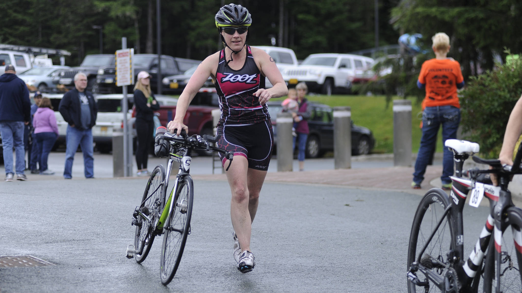 Kimberly Campbell runs after finishing the biking leg of the 2018 Aukeman Triathlon at the University of Alaska Southeast . (Nolin Ainsworth | Juneau Empire)