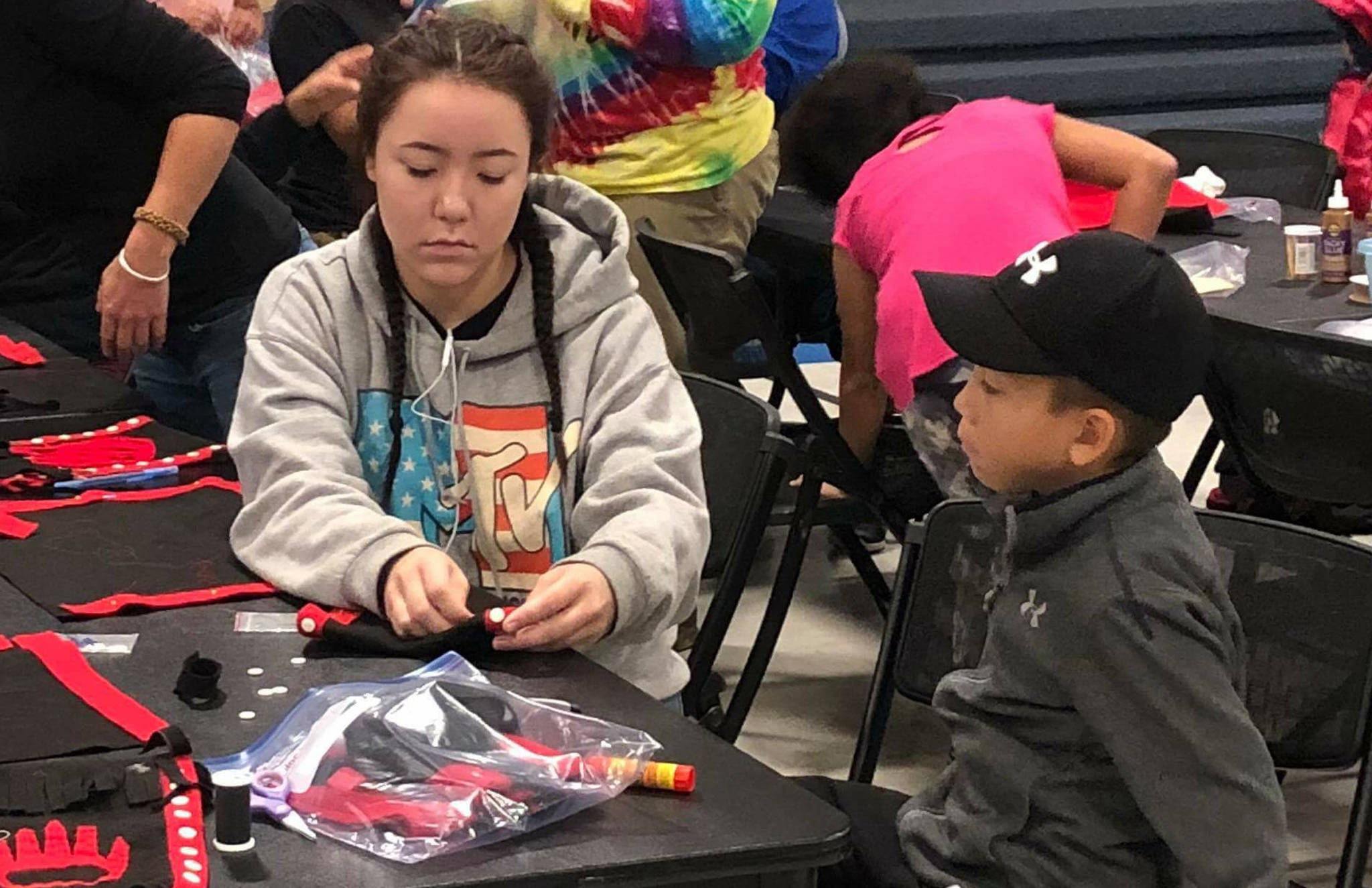 Sydney Johnson helps her brother Tristan with an art project at an Alaska Native culture camp on Thursday, Aug. 2, 2018. (Courtesy Photo | Rose Willard)