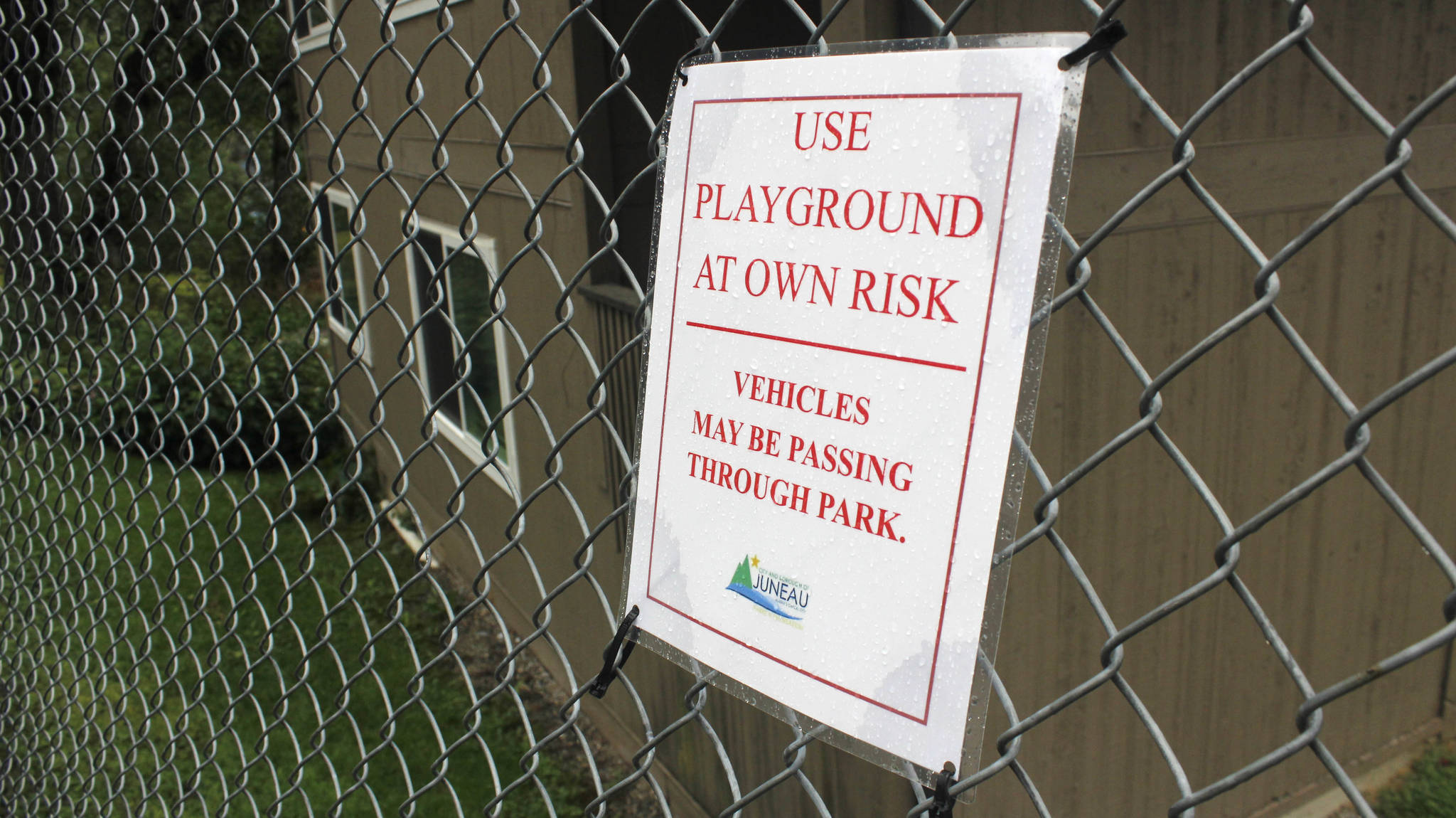 A sign warning of cars going through Chicken Yard Park is pictured on Tuesday, Aug. 7, 2018. The Parks and Recreation department posted the signs this summer. (Alex McCarthy | Juneau Empire)