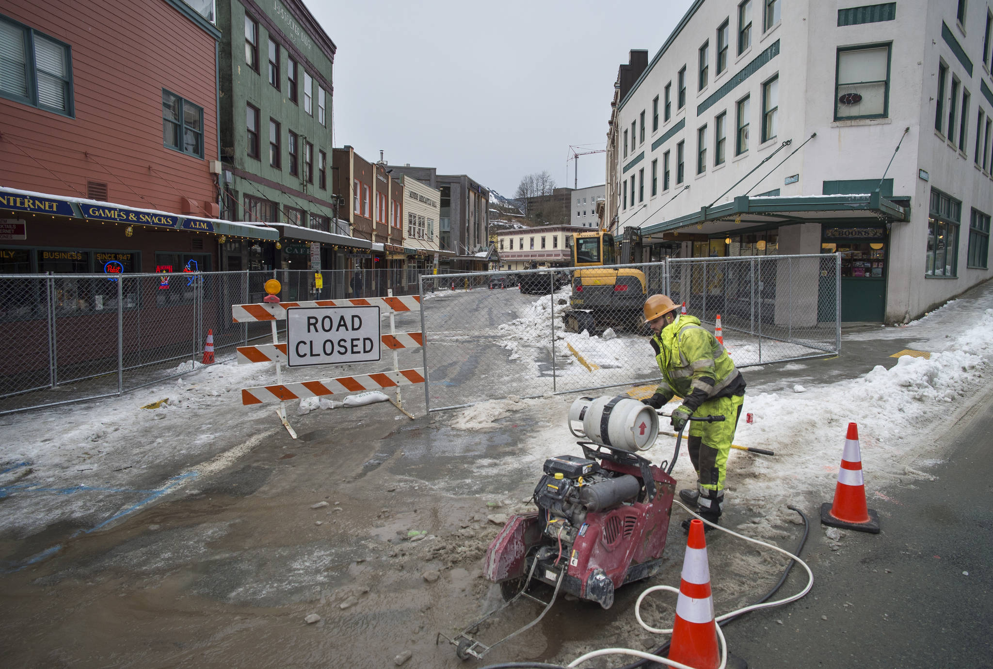 Mariyan Aleksiev, of Earthmovers, cuts into the pavement at the intersection of Franklin and Front Streets on Tuesday, Feb. 20, 2018. A section of Front Street will be closed as remodeling work to replace utilities, pavement, sidewalk and lighting fixtures take place over the next few months. (Michael Penn | Juneau Empire File)