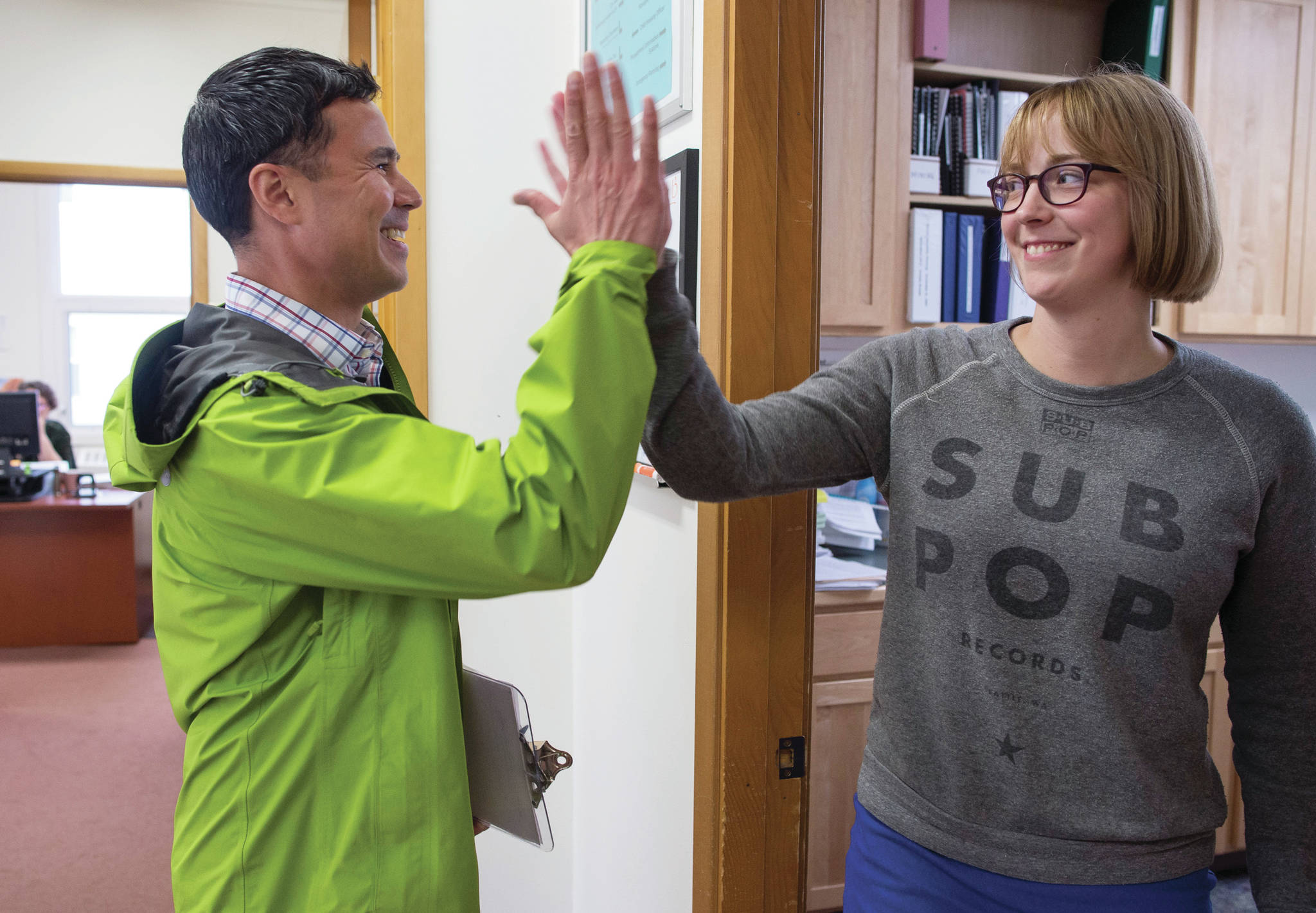 Norton Gregory gives Carole Triem a high-five as he arrives at City Hall to resign from his Assembly seat to run for mayor on Monday, August 13, 2018. Triem was waiting for Gregory to resign so she could file to run for his areawide seat. The Candidate Filing Period for the Oct. 2 Municipal Election closed Monday. (Michael Penn | Juneau Empire)