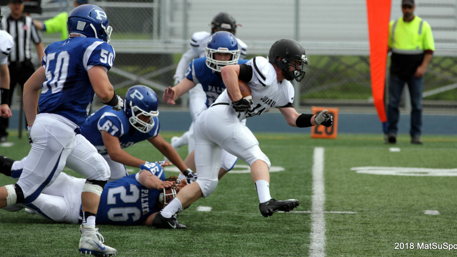 Juneau running back Caleb Traxler breaks a Palmer tackle in his team’s 31-8 loss to the Moose in its first game of the season last Saturday. The co-op team plays West Anchorage on Saturday night in Anchorage. (Courtesy Photo | MatSuSports.net)