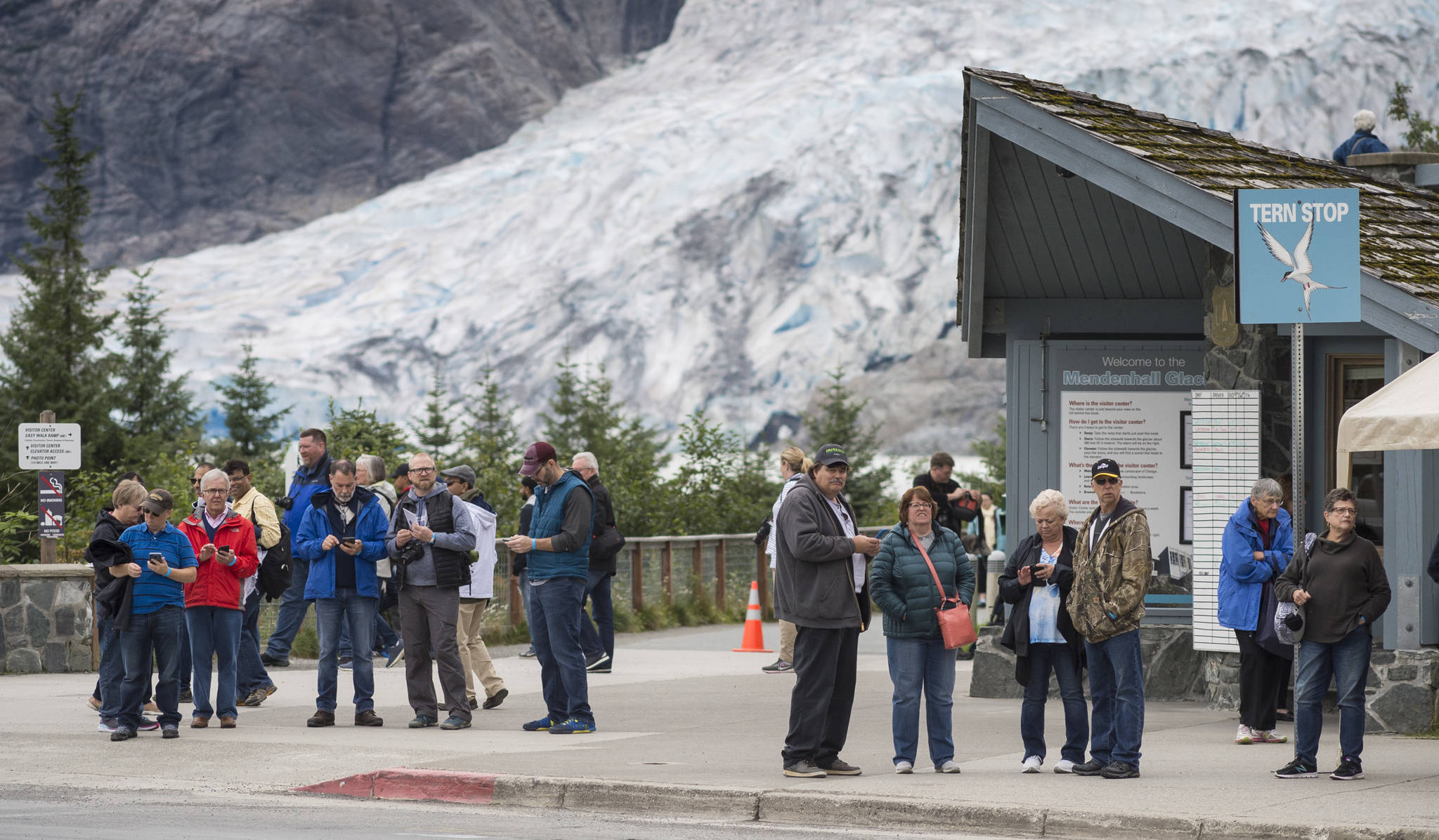 Visitors wait for the buses at the Mendenhall Glacier Visitor Center on Thursday, August 16, 2018. (Michael Penn | Juneau Empire)