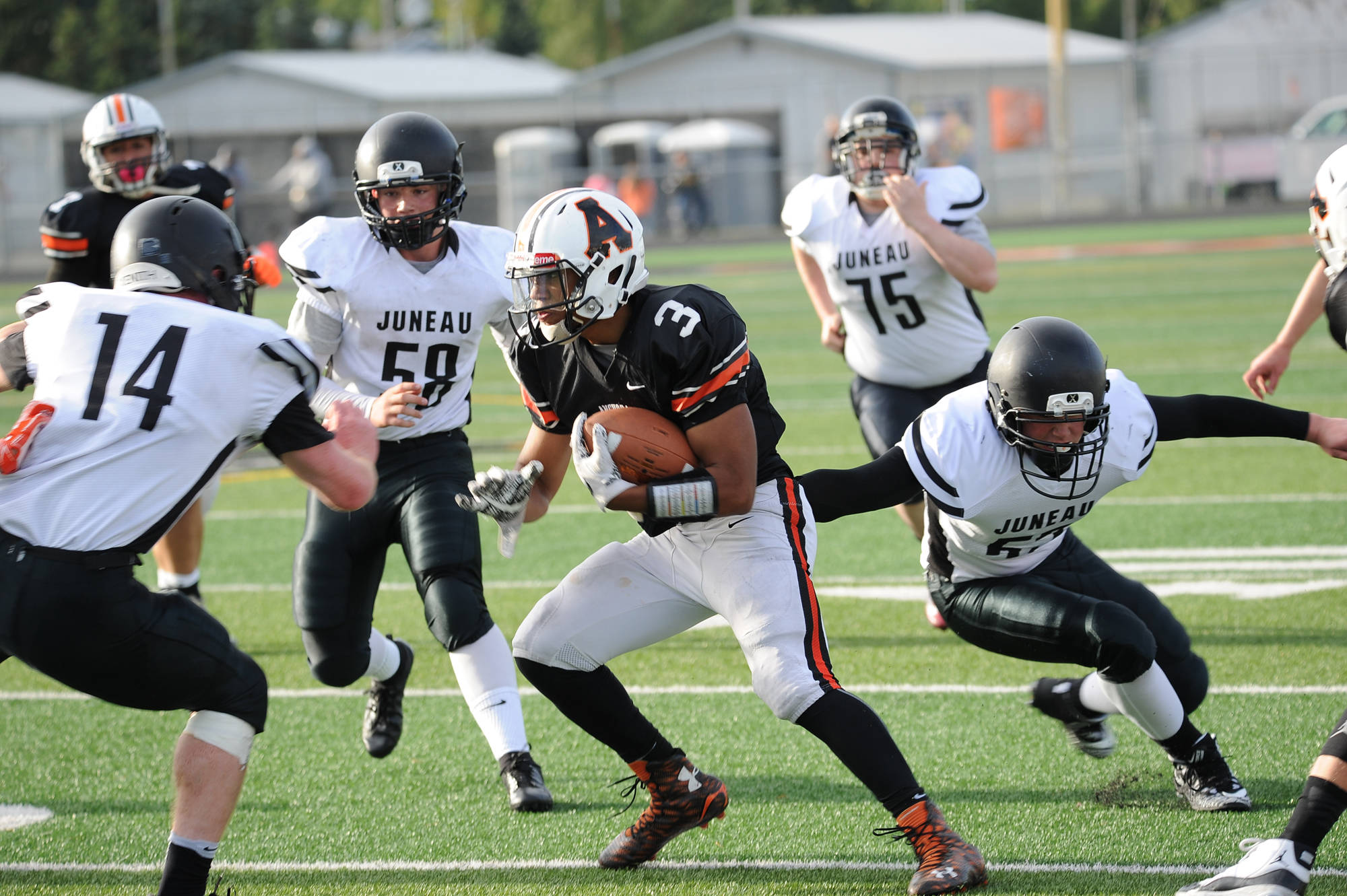 Three Juneau defenders converge on West’s Jonah Gladney. (Michael Dinneen | For the Juneau Empire)