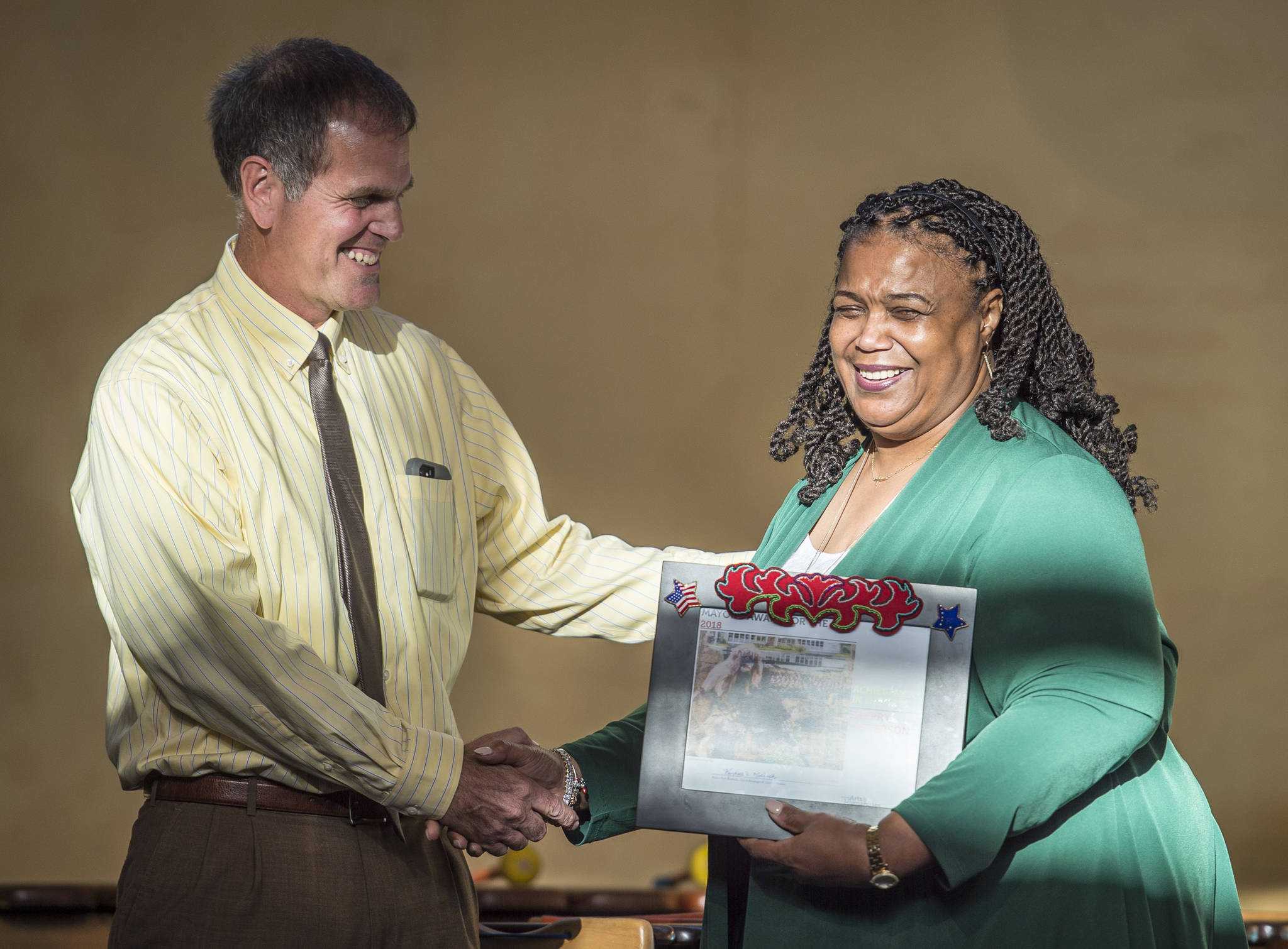 Deputy Mayor Jerry Nankervis congratulates Sherry Patterson for the Achievement in the Arts Award during the Mayor’s Awards for the Arts at the Juneau Arts & Culture Center on Friday, August 17, 2018. (Michael Penn | Juneau Empire)