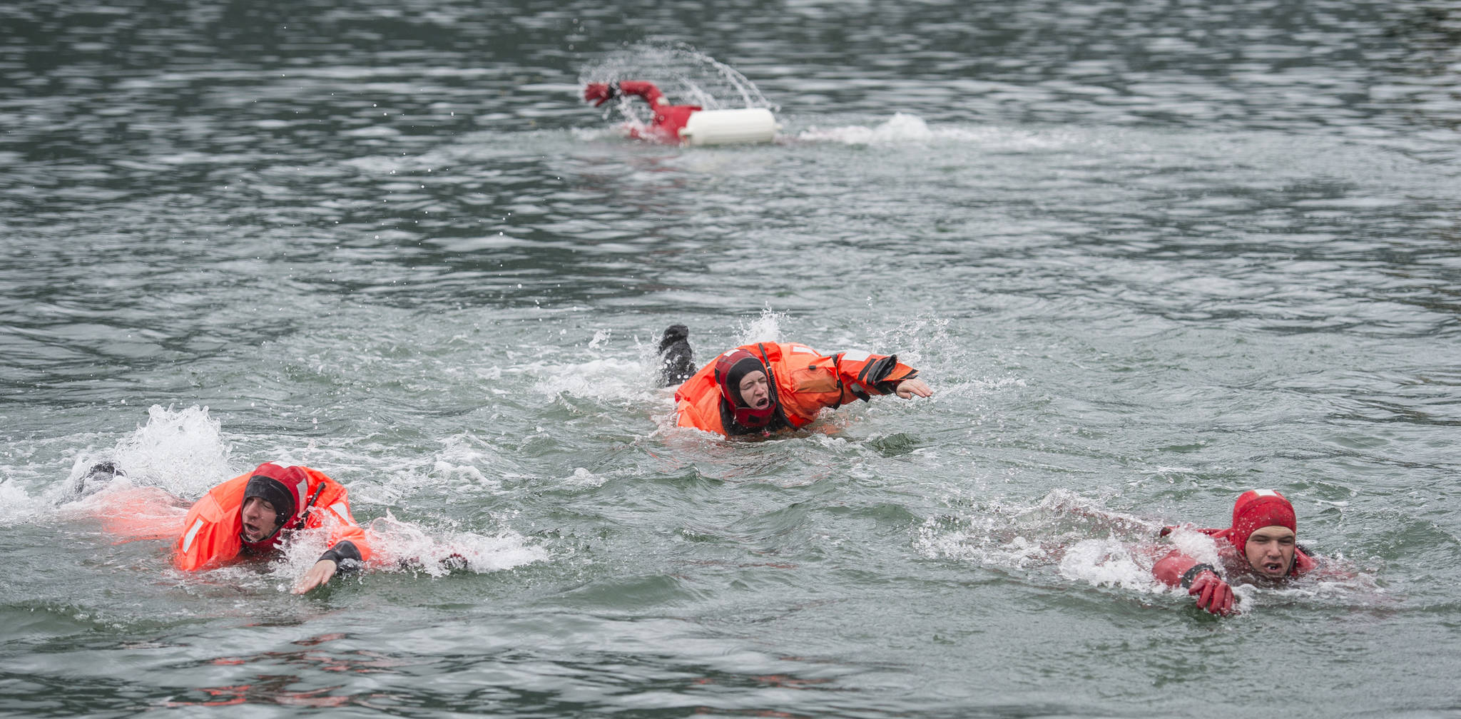 U.S. Coast Guard teams from the Guard Cutters Hickory, Sycamore, Anthony Petit and Kukui compete in the survival suit swim during the Buoy Tender Olympics at Station Juneau on Wednesday, Aug. 22, 2018. (Michael Penn | Juneau Empire)