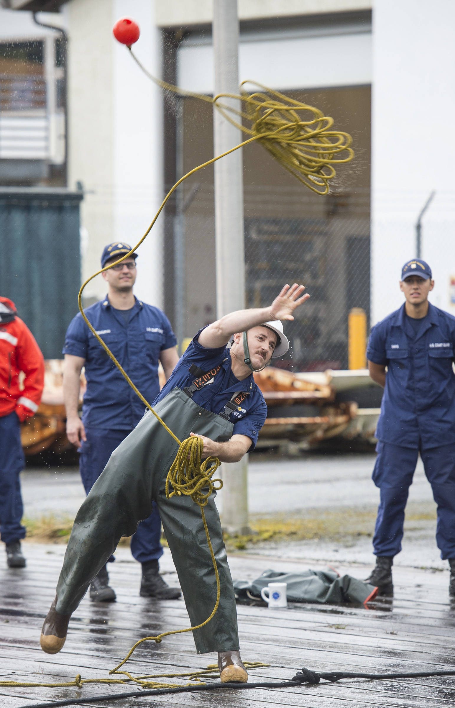 Senior Chief Petty Officer Joe Baxter, of the Anthony Petit, competes in the line toss during the Buoy Tender Olympics at Station Juneau on Wednesday, Aug. 22, 2018. (Michael Penn | Juneau Empire)
