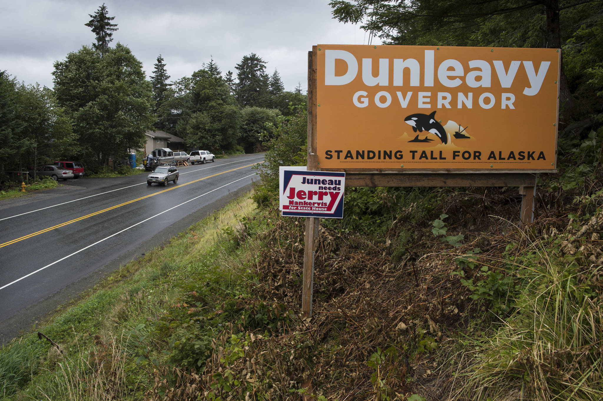 Mike Dunleavy for governor and Jerry Nankervis for state house election signs are seen on Egan Drive at 17 Mile on Friday, Aug. 24, 2018. Alaska statute states signs on private or commercial property cannot be located within 660 feet of a state-maintained road or “with the purpose of their message being read from the main traveled way.” (Michael Penn | Juneau Empire)